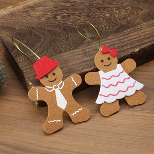 Detailed view of gingerbread man felt Christmas tree ornaments on a rustic wooden background
