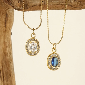 Detailed view of titanium necklaces with blue and clear heart zirconia on driftwood