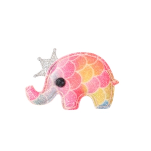 Macro detail of elephant hair clip featuring rainbow glitter finish and silver crown