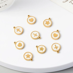 Detail of gold-plated shell charms with star, heart, and cross patterns for DIY jewelry