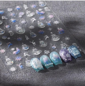 Detailed view of Christmas nail art stickers featuring 3D snowflakes and reindeer patterns