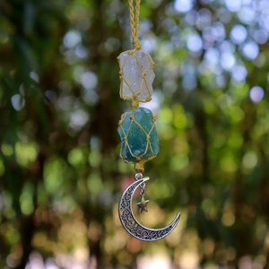 Detail of handmade crystal car hanging with white and green stones and silver moon charm