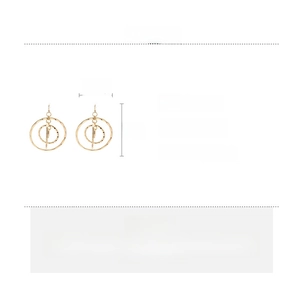 Close-up of golden hollow multi-layered round earrings with textured hammered finish