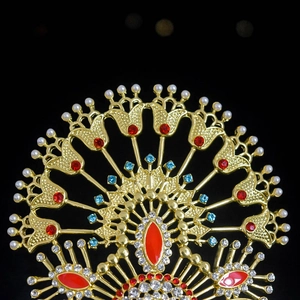 Close-up of luxury bridal crown with pearls, red and blue gemstones on gold metal