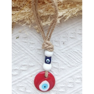 Handmade red evil eye wall hanging with jute rope and decorative beads for home decor