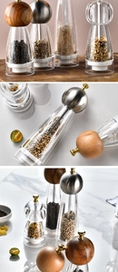 Detail view of manual pepper mill set with acacia wood and acrylic body on marble surface