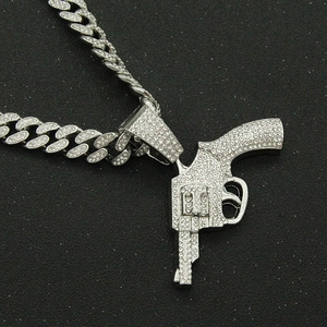 Hip hop silver Cuban chain with iced-out revolver pendant and shimmering rhinestones