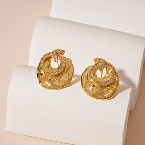 Irregular golden earrings with zircon circle on minimalist geometric display base