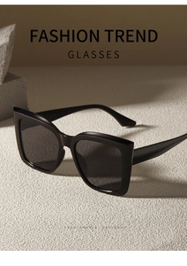 Detail view of bold square cat-eye sunglasses on stone pedestal with soft side shadows