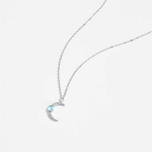 Macro detail of S925 silver crescent moon necklace with iridescent moonstone and zircons