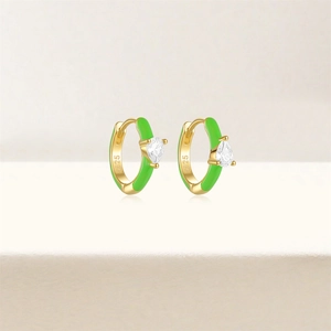 Close-up of S925 sterling silver earrings with green enamel and teardrop zircon details