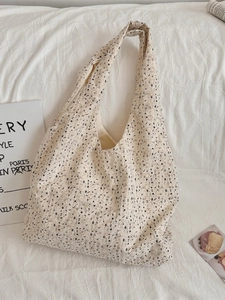 Minimalist cream canvas tote bag with floral embroidery and cutout pattern for women