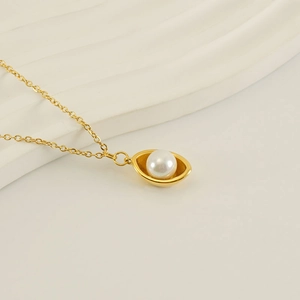 Collier minimaliste en acier inoxydable plaqué or 18k avec perle ronde sur fond blanc texturé