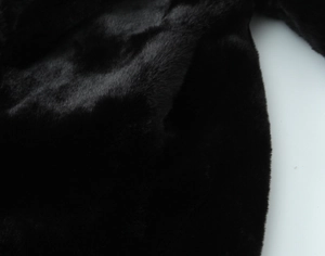 Vue macro détaillée montrant la texture lisse et le brillant de la fausse fourrure noire