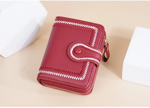 Detail view of red bifold wallet with contrast white stitching and side zipper