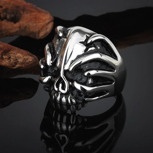 Macro shot of punk style skull ring with silver and black steel contrast on mirror