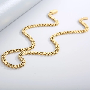 Detailed top view of gold-plated stainless steel Cuban link chain on white background