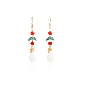 Detail of vintage long tassel earrings with red beads, cyan leaves, and white flower buds