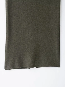 Détails de la maille à losanges vert olive foncé et de l'ourlet de l'ensemble tricoté