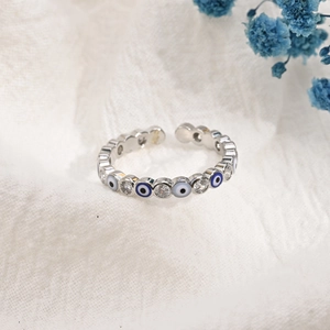 Detailed view of evil eye ring with blue enamel and sparkling cubic zirconia stones