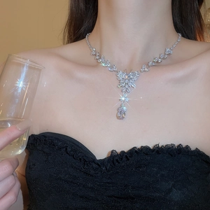 Detail of silver butterfly tassel necklace with zircon water drop pendant on a model