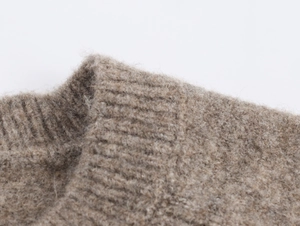 Close-up of ribbed crewneck and soft brushed knit texture on brown cardigan