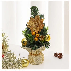 Detailed close-up of mini Christmas tree with golden sequins, flowers, and fabric base