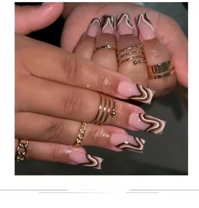 Detail of square nails with French fluid wave patterns in brown and white tones