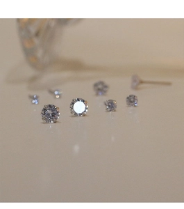 Macro shot of 925 silver stud earrings with clear cubic zirconia in multiple sizes