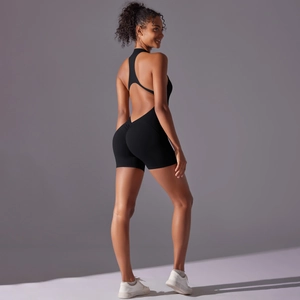 Detail view of high-stretch black yoga jumpsuit with racerback and open back design