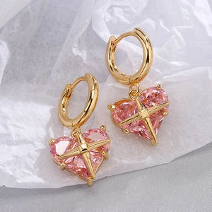 Pink heart-shaped zircon earrings with gold plating and star motif on white paper