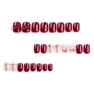 Glossy burgundy press-on nails set with white plaid patterns, red bows and rhinestones