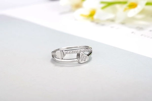 Detail of silver double-layered open ring with sparkling crystal and smooth heart shapes