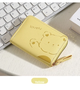Detail of yellow accordion card holder featuring a cute bear and lovely text design