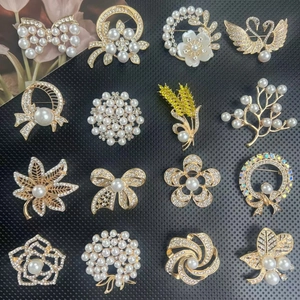Vintage gold alloy brooches set with pearls and crystals in varied floral shapes