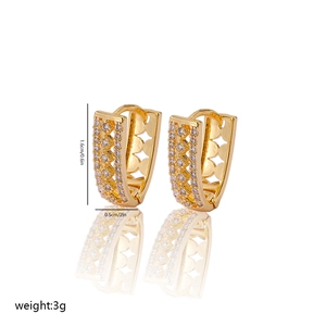 Detailed view of V-shaped gold earrings with zircon pavé and cutout star patterns