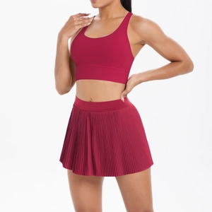 Detail view of the deep red pleated tennis skirt and high-elastic sports bra set
