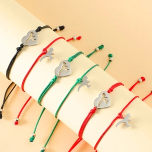 Close-up of woven heart charm bracelets with animal silhouettes on a display stand