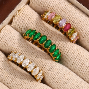 Macro shot of three gold rings with oval colored zircon gemstones in a linen jewelry box