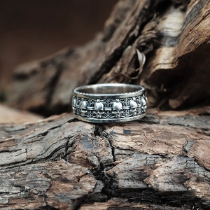 Detailed macro view of S925 silver skull and iris engraving on a vintage gothic ring