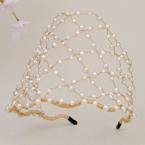 Detail of handmade bridal headband featuring woven pearls and golden wire mesh