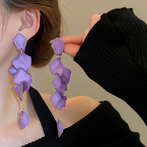 Macro shot of long purple petal tassel earrings with matte finish on a female model