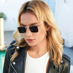 Classic rectangle gold metal frame sunglasses with dark lenses on a stylish model