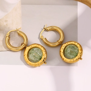 Detail of vintage 18K gold plated earrings with hammered metal and green cracked glass beads