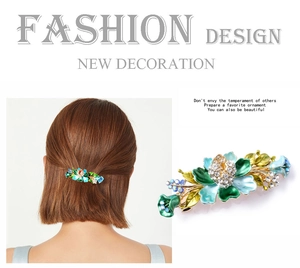 Detailed close-up of vintage flower hair clip with green enamel and sparkling rhinestones