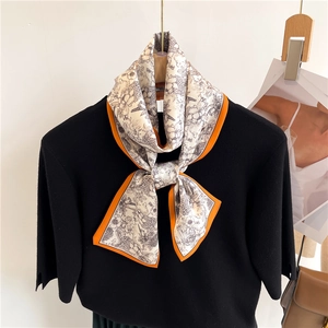 Foulard en soie à imprimé fleuri et bordure orange sur un haut en tricot noir pour femme
