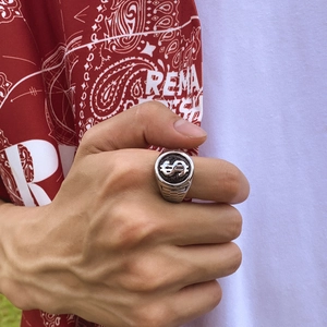 Silver dollar sign ring for men featuring vintage punk style on a male model's hand