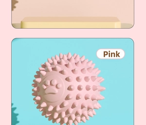 Detail of pink TPR pet toy ball featuring durable massage spikes and cute paw print design