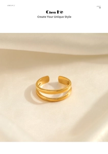 Detail of minimalist gold double-layered open ring on soft beige satin background
