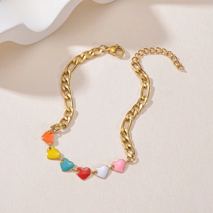 Detail of golden Figaro chain bracelet featuring colorful enamel heart pendants and lobster clasp